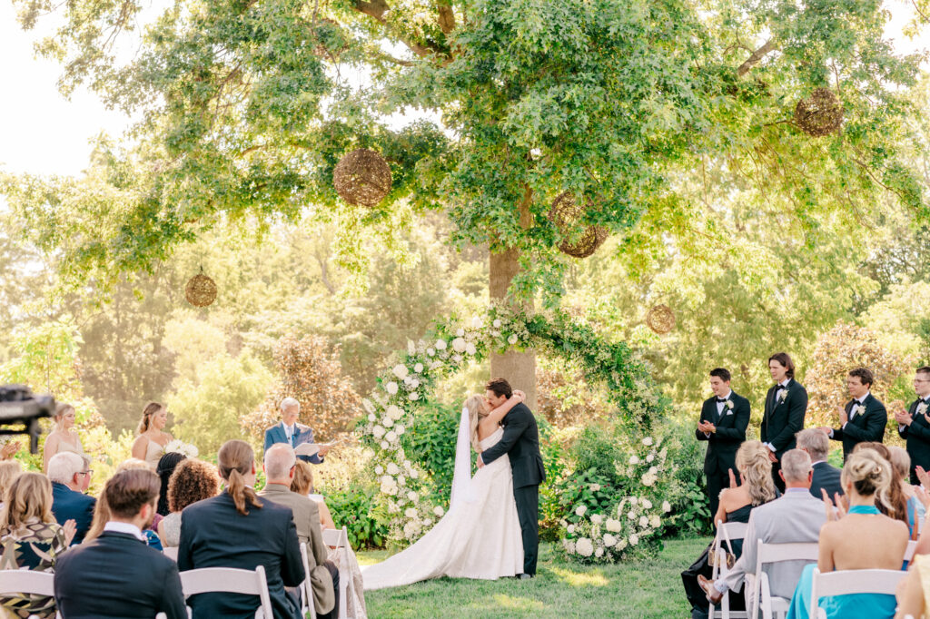 Anna & Codey sealing their wedding vows with a kiss at their July 4th Wedding at Jorgensen Farms in Westerville, OH