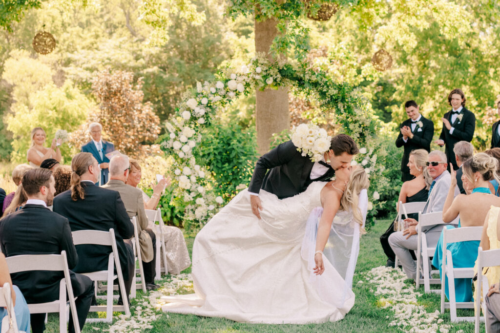 Anna & Codey stop for a quick kiss during the recessional after their wedding ceremony at Jorgensen Farms in Westerville, OH