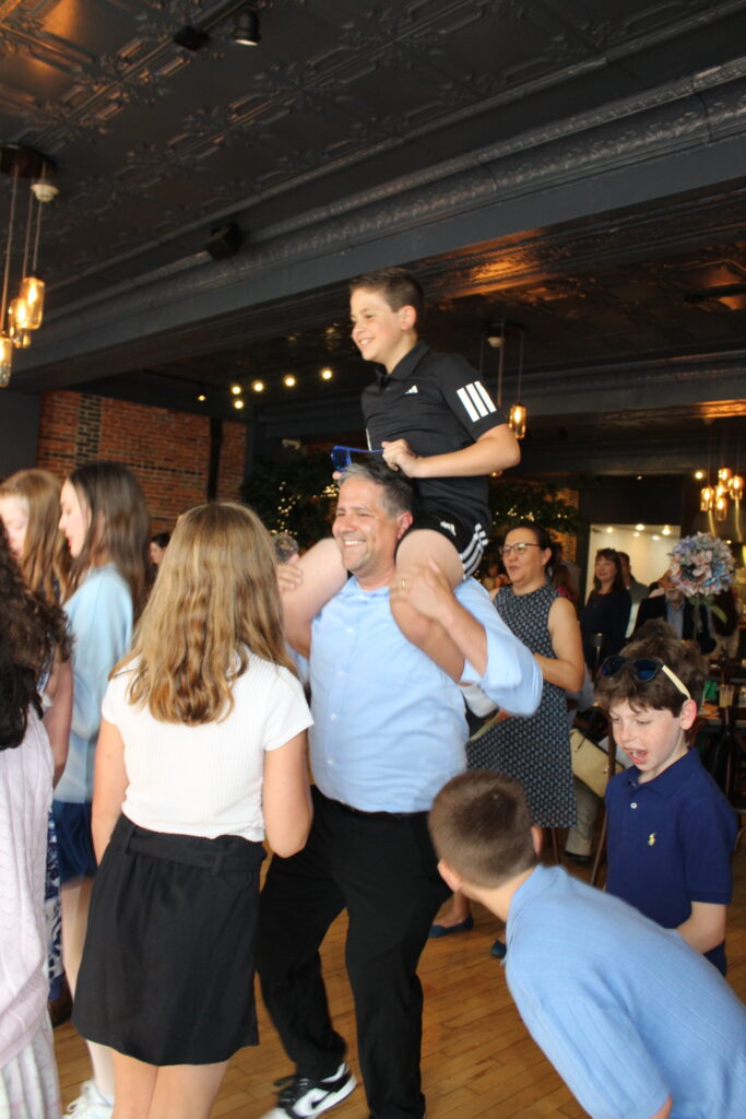 Isla and her friends and family on the dance floor at her Bat Mitzvah in Columbus, OH