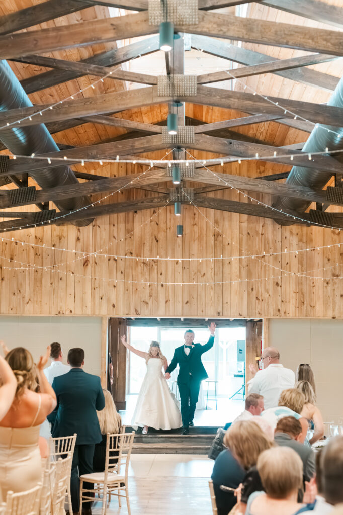 Anna & Codey make their grand entrance into their wedding reception at the Historic Barn at Jorgensen Farms in Westerville, OH