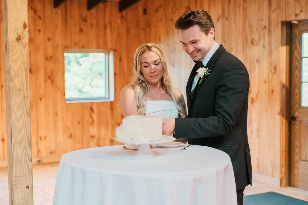 Anna & Codey cutting their cake during their wedding reception at Jorgensen Farms in Westerville, OH