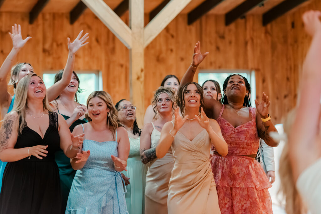 All the single ladies getting ready for Anna to toss the bouquet inside the Historic Barn at Jorgensen Farms in Westerville, OH