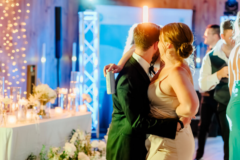 Anna & Codey's guests on the dance floor at their wedding reception inside the Historic Barn at Jorgensen Farms