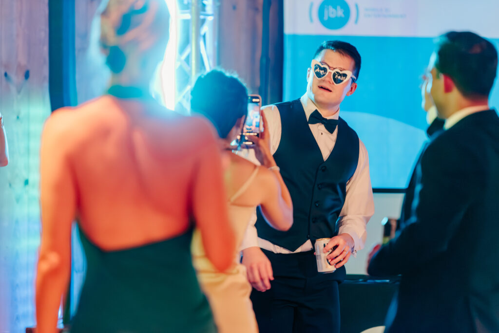 Guests taking pictures on the dance floor at Anna & Codey's Wedding Reception at Jorgensen Farms