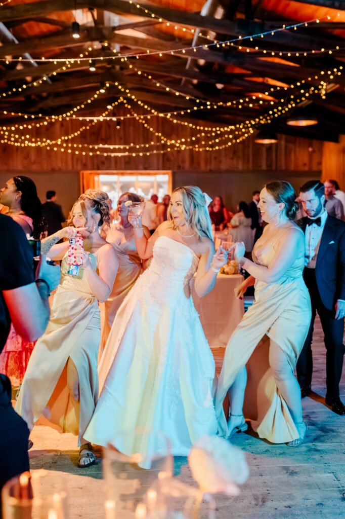 Anna and her friends and family on the dance floor at her wedding reception at Jorgensen Farms