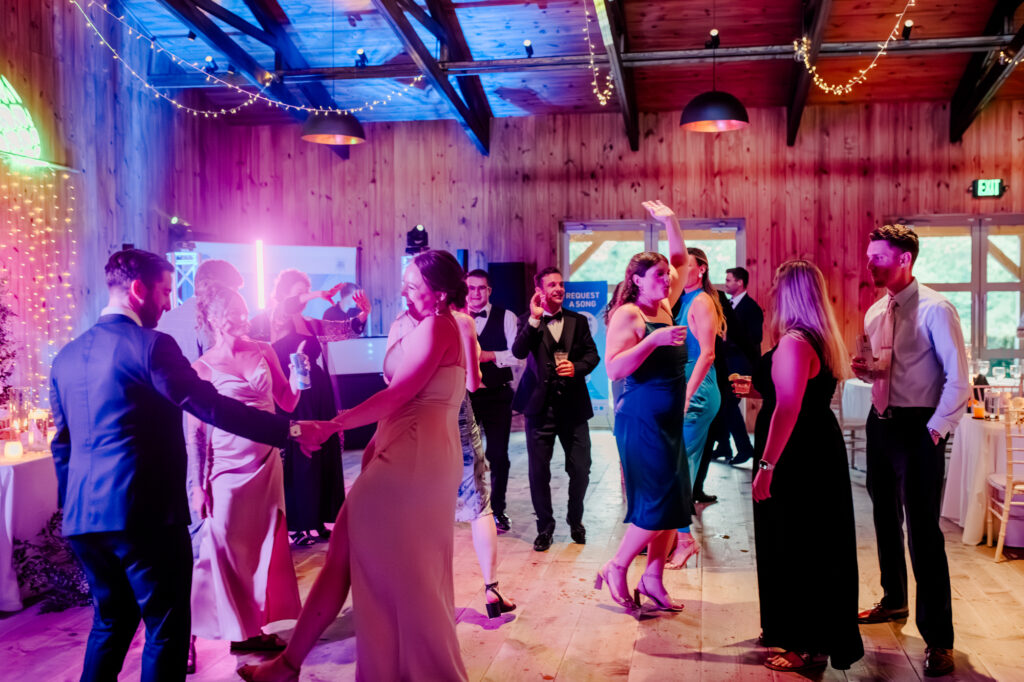 Anna & Codey's guests on the dance floor at their wedding reception inside the Historic Barn at Jorgensen Farms.
