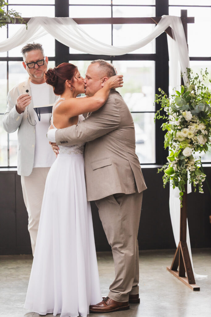 Susan & Ryan sealing their wedding vows with a kiss inside the Sunroom at Seventh Son Brewing in Columbus, OH