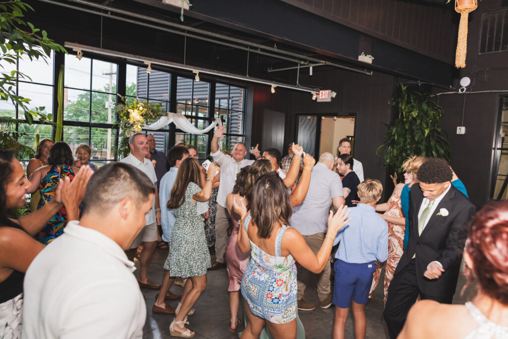 Family and friends on the dance floor at Susan & Ryan's Wedding Reception at Seventh Son Brewing in Columbus, Ohio
