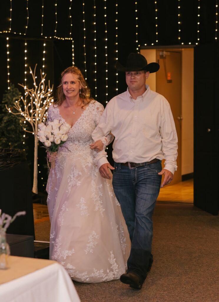 The bride & groom entering their wedding reception at The Grove By The River in Newark, Ohio