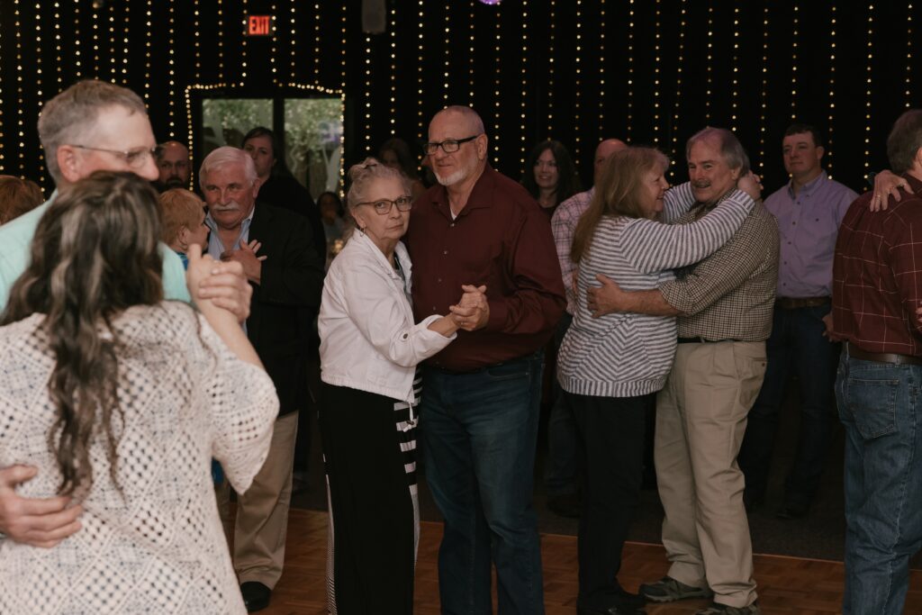 Kasey & John's guests dancing during the Anniversary Dance during their wedding reception at The Grove By The River in Newark, Ohio