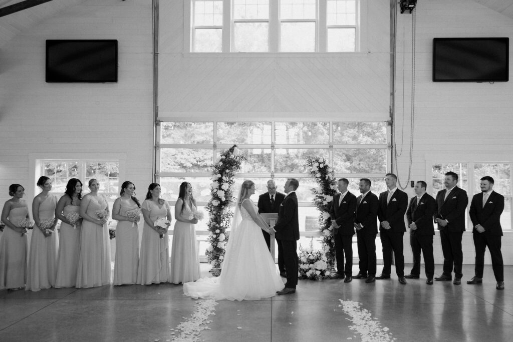 Allison, Joe, and all of their bridesmaids, groomsmen, and the officiant during their wedding ceremony inside Williams Farm in Pataskala, Ohio