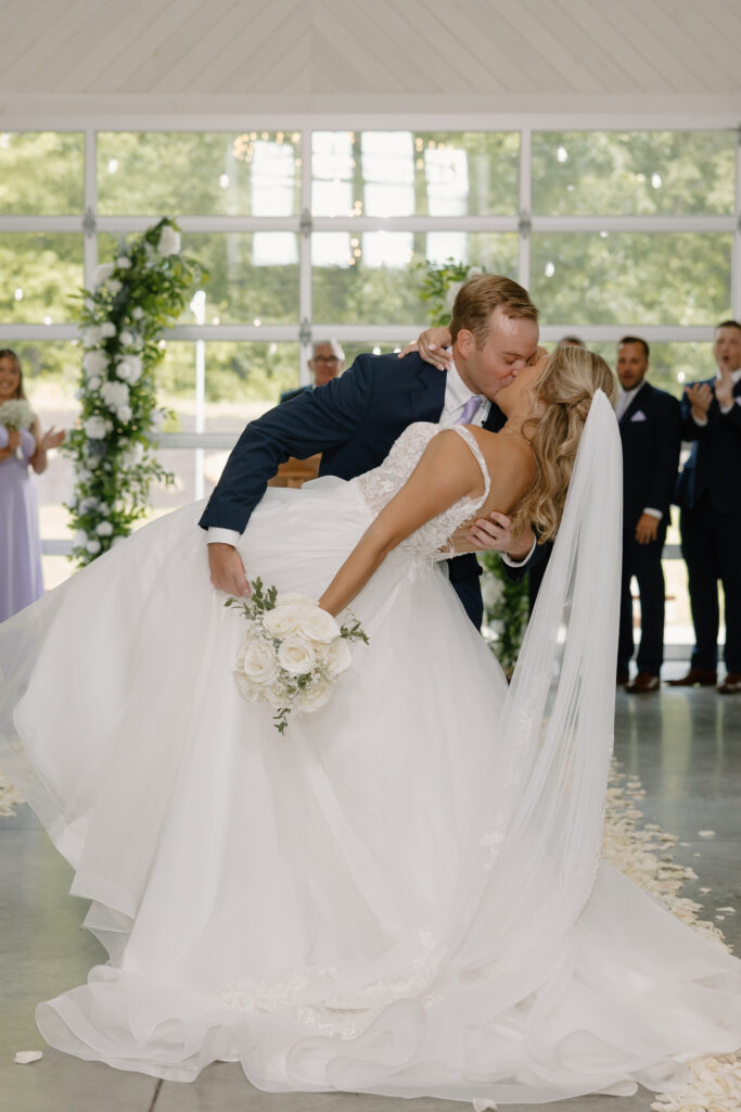 Allison & Joe stop for one more kiss during their recessional following the wedding ceremony in Pataskala, Ohio