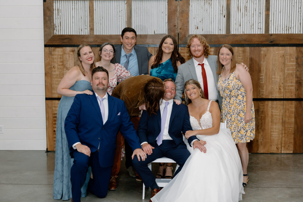 One of their guests surprising Joe with a kiss during the Photo Dash at their wedding reception in Pataskala, Ohio