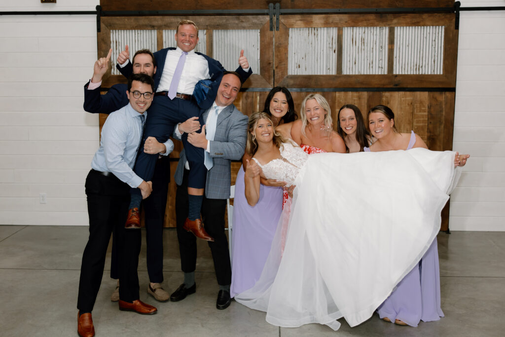 Allison & Joe lifted up by their guests during the photo dash at their wedding reception in Pataskala, Ohio