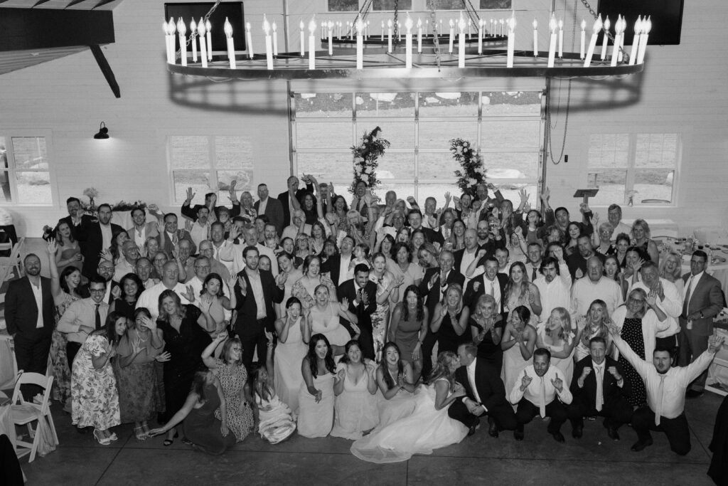 A picture of Allison, Joe, and all their guests at their wedding reception inside Williams Farm in Pataskala, Ohio