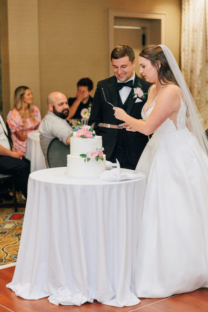 Ann & Bryse cut the cake at their wedding reception at Granville Inn