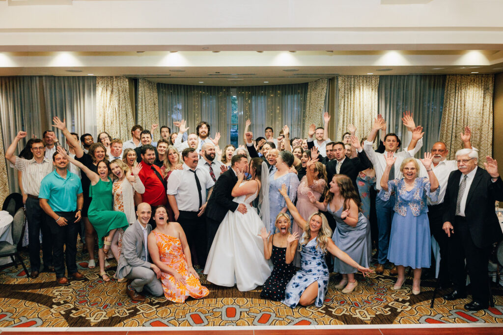 Ann & Bryse surrounded by their guests on the dance floor for a group picture inside the Denison Room inside Granville Inn.