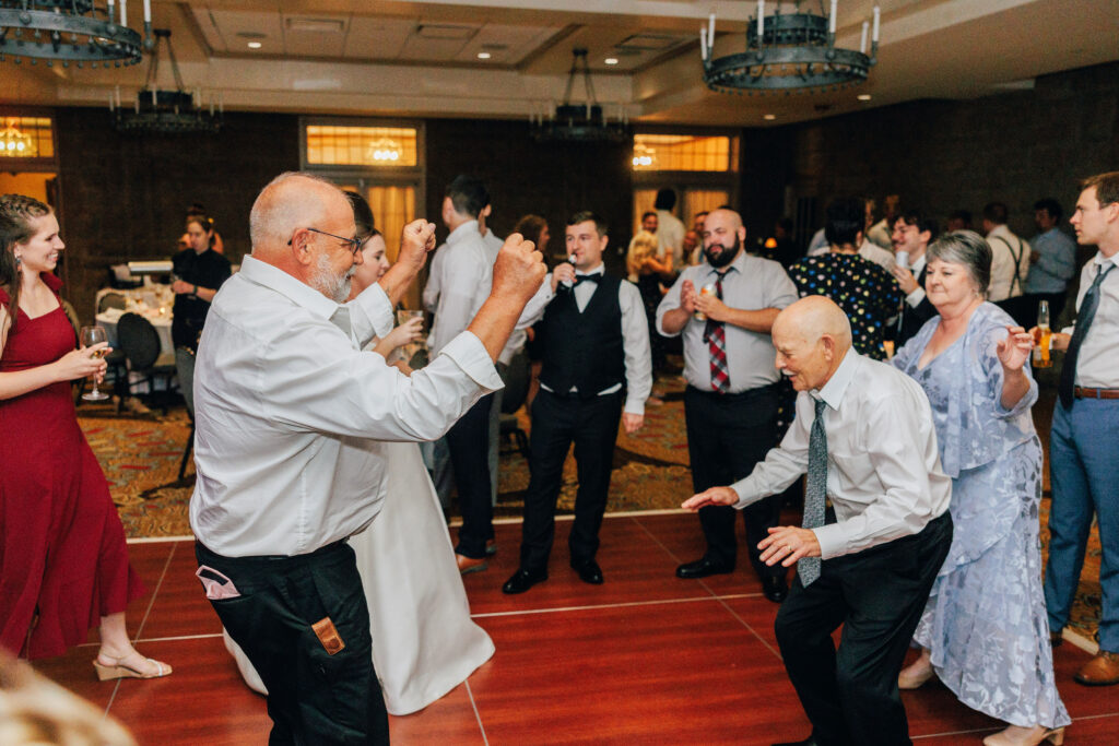 Ann's Dad & Bryse's Dad surrounded by their friends and family on the Dance Floor at Ann & Bryse's Wedding Reception