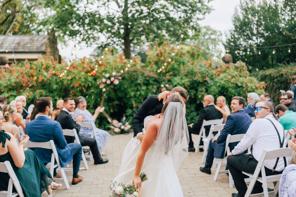 One more kiss for Ann & Bryse as they made their way back up the aisle during the recessional at their wedding ceremony in Granville, Ohio
