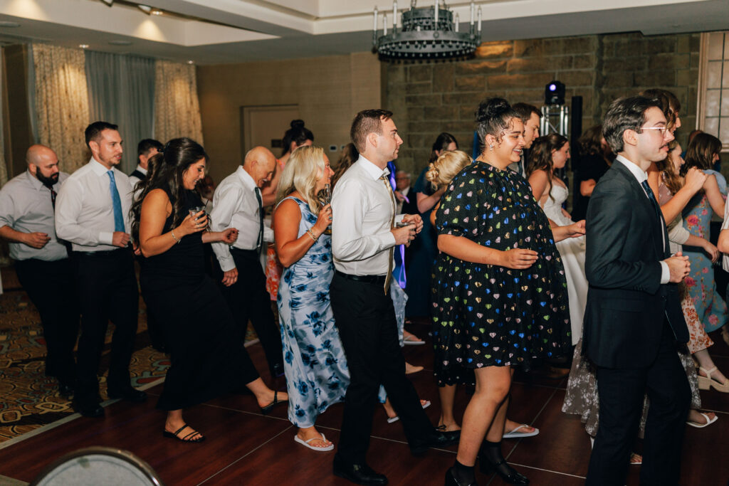 Ann & Bryse's guests on the dance floor at their wedding reception at Granville Inn