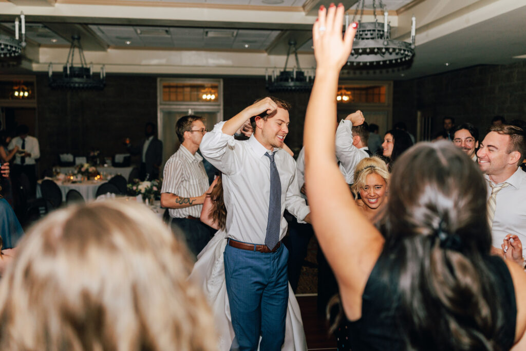 Hands in the air at Ann & Bryse's Wedding Reception in the Denison Room at Granville Inn in Granville, Ohio