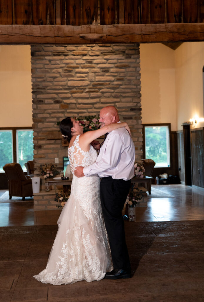 Sarah and her dad sharing a laugh and a dance during her wedding reception at The Old Barns at Dry Run Farms