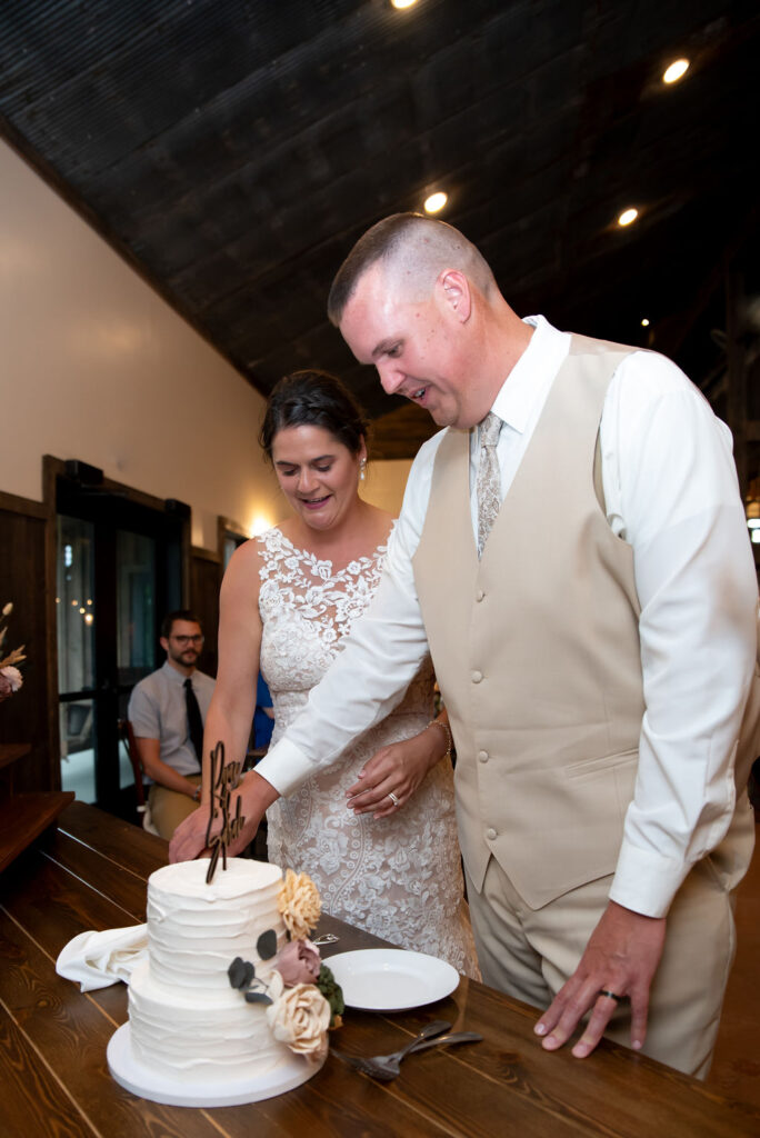 Sarah & Ryan cut their cake at their wedding reception at The Old Barns at Dry Run Farms in Williamsport, Ohio