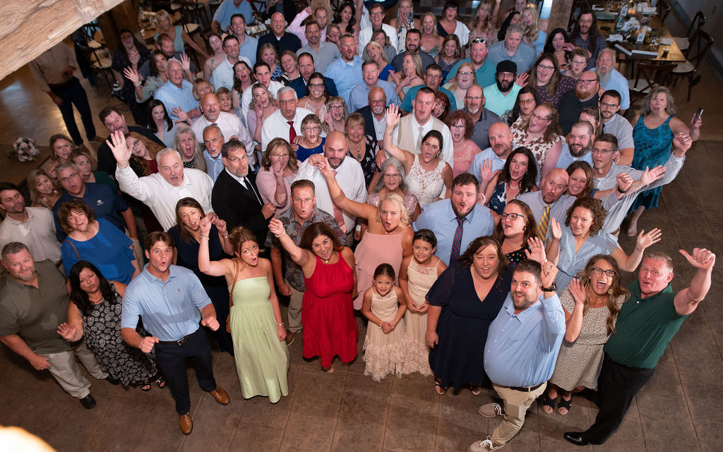 A group picture including Sarah, Ryan, and all their guests right before we opened up the dance floor for their wedding reception at The Old Barns at Dry Run Farms in Williamsport, Ohio
