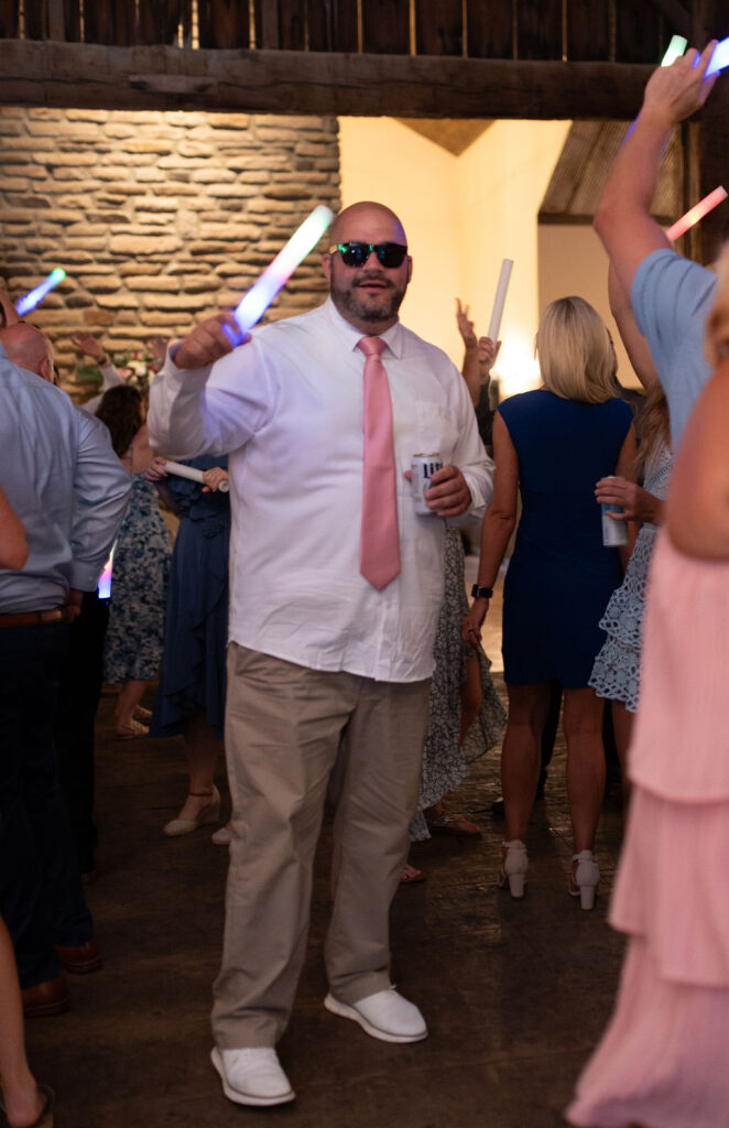 Sunglasses, glowstick, and ready to party at Sarah & Ryan's Wedding Reception