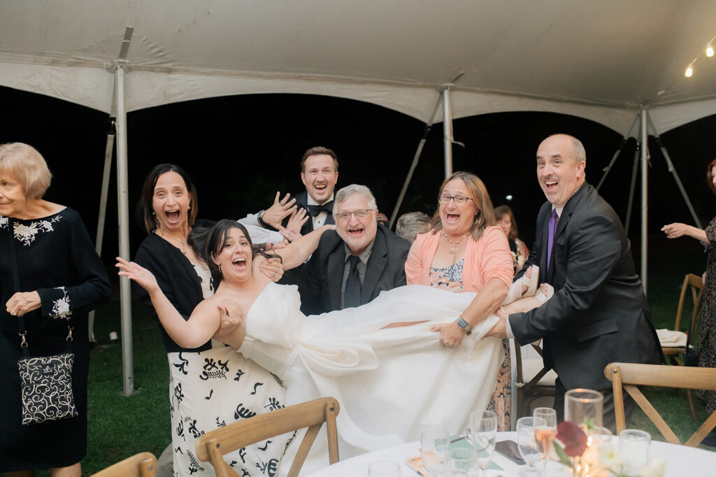 Carly is in the air as part of the table dash during her wedding reception at Bryn Du Mansion
