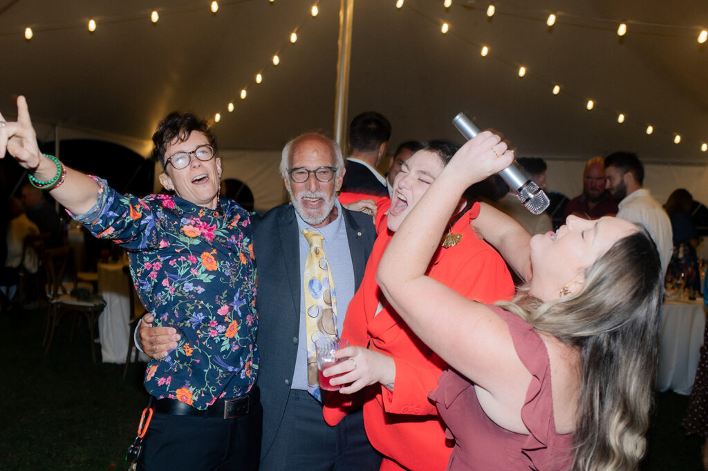 Guests singing along during Carly & Roy's Wedding Reception at Bryn Du Mansion
