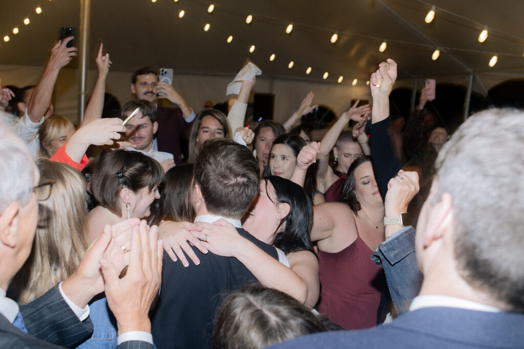 Everyone celebrating at Carly & Roy's Wedding Reception at Bryn Du Mansion in Granville, Ohio