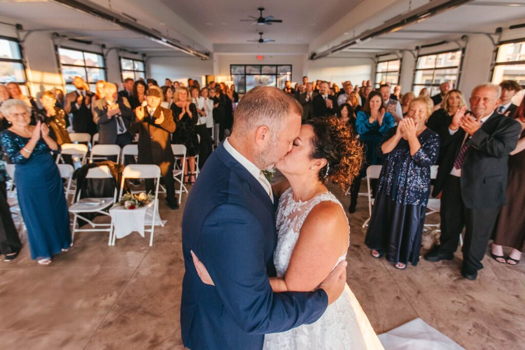 Heidi & Rusty sealing their vows with a kiss at their wedding ceremony at the Wenbeck Wedding & Events Center in Lewis Center, OH
