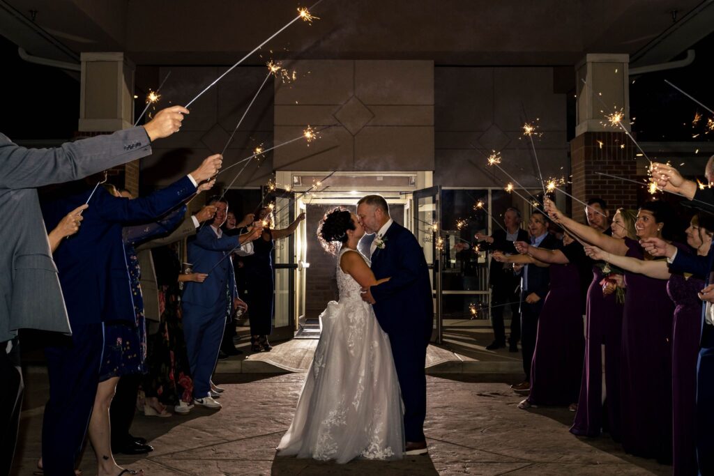 Heidi, Rusty, and their guests outside of the Wenbeck Wedding & Events Center for a Sparkler Send Off