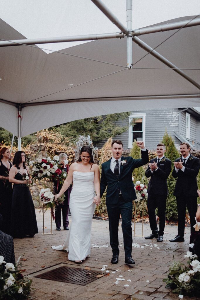 Morgan & Jonny exiting their wedding ceremony in the Courtyard at Granville Inn