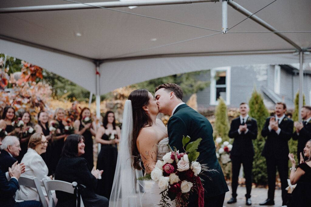 Morgan and Jonny stop during the recessional for one more kiss at Granville Inn