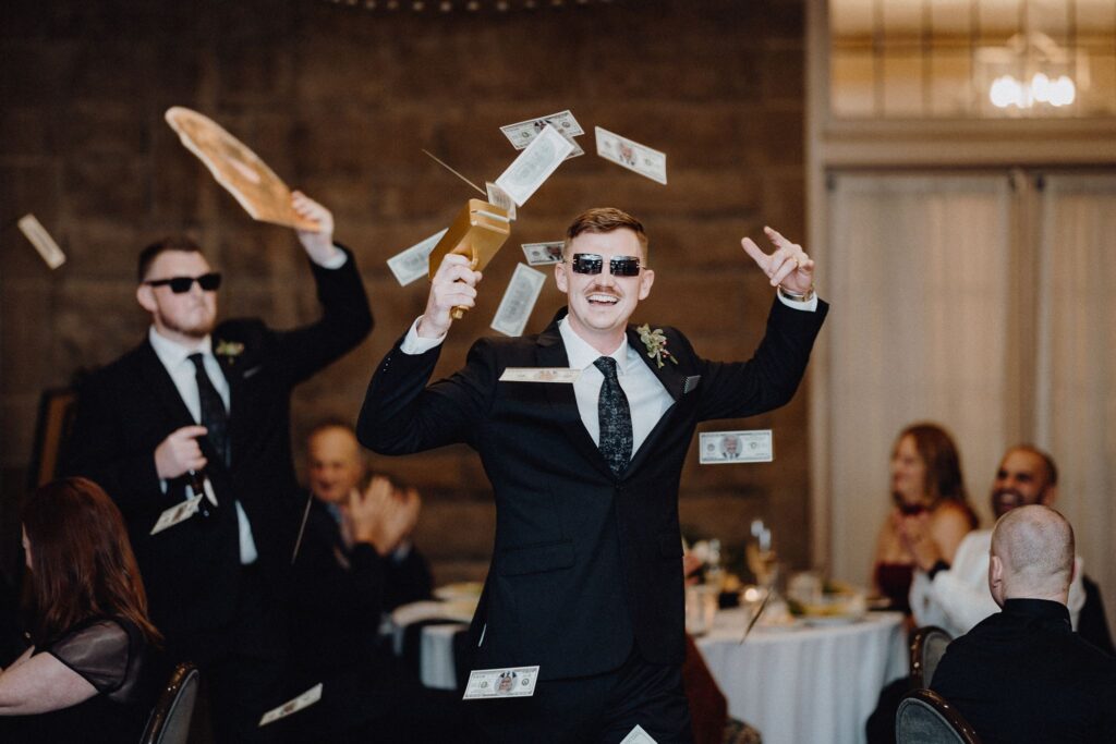 The groomsmen enter the wedding reception in the Denison Room at Granville inn