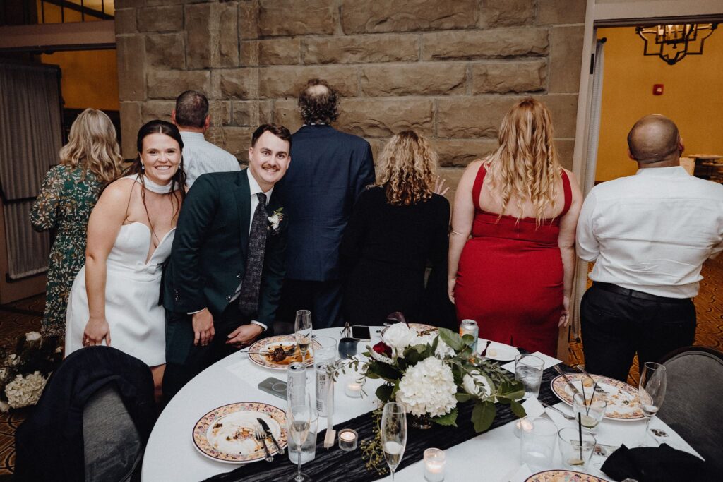 Morgan and Jonny pose with their guests for the photo dash at their wedding reception